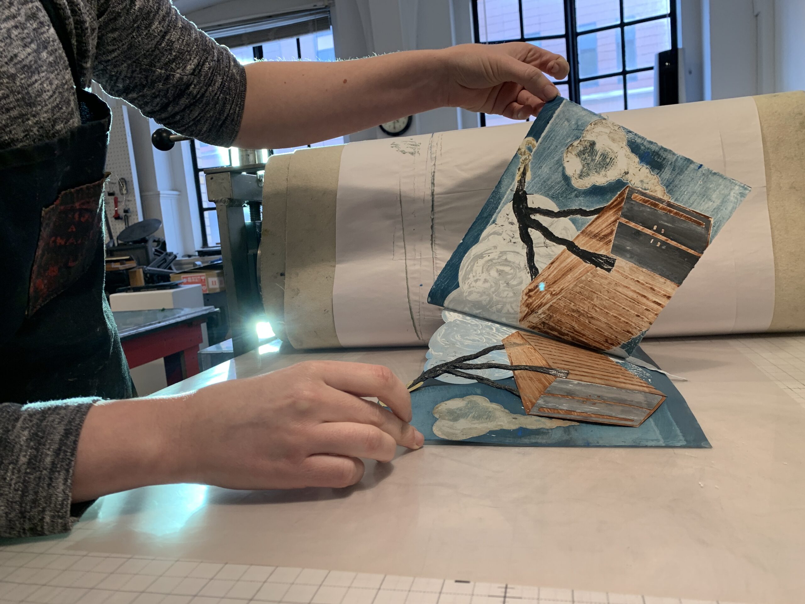 Workshop participant pulling a monotype print.